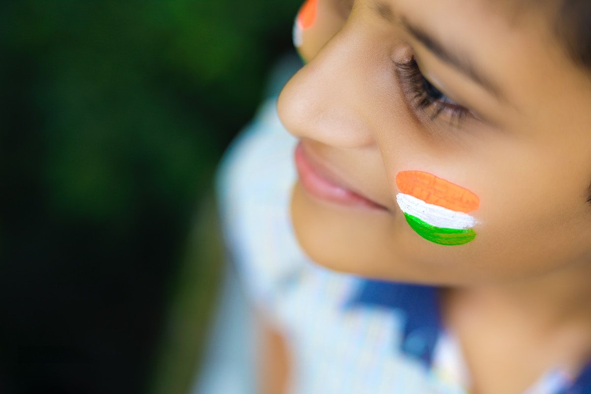girl with an Indian flag painted on her cheek