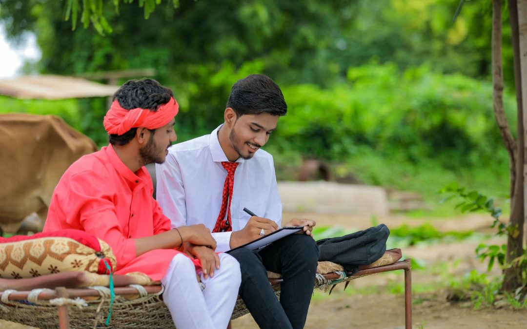 Two Indian men sitting outside talking